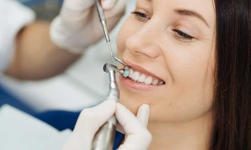 Young woman smiling during dental procedure